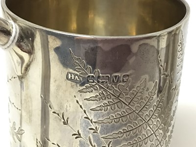Lot 160 - Victorian silver mug with engraved floral decoration ( London 1862) 9cm high and another similar (Sheffield 1888) 9.5 cm high (2)