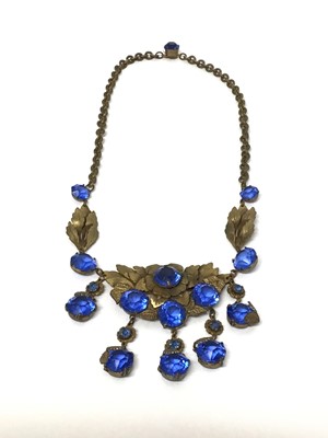 Lot 163 - 1930s gilt metal and blue glass set necklace with leaf and flower head decoration