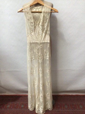 Lot 2115 - 1940s all over lace evening dress appliqued linen decorated net lace with satin silk insert and a cream shoe-sting strap underdress.