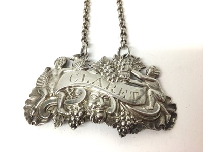 Lot 182 - George III silver claret label with putti and grapevine decoration (Birmingham 1813) 6.5 cm