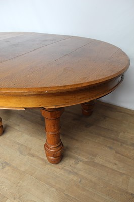 Lot 131 - Victorian oak extending dining table with D-ends, one extra leaf (would take several more), on six turned legs with very large brass and ceramic castors, 204cm long with one leaf present x 146cm wi...
