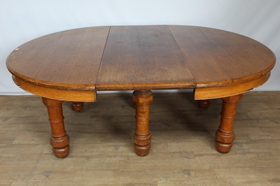Lot 131 - Victorian oak extending dining table with D-ends, one extra leaf (would take several more), on six turned legs with very large brass and ceramic castors, 204cm long with one leaf present x 146cm wi...