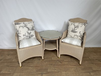 Lot 148 - Vincent Sheppard lloyd loom type pair of chairs and matching circular two tier table