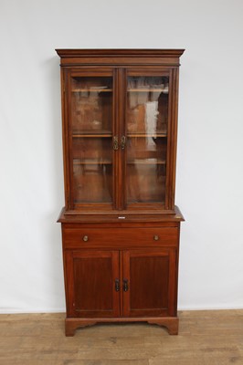 Lot 153 - Edwardian mahogany two height bookcase of narrow proportions with single drawer and twin cupboards below, 76cm wide x 28cm deep x 180cm high