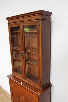 Lot 153 - Edwardian mahogany two height bookcase of narrow proportions with single drawer and twin cupboards below, 76cm wide x 28cm deep x 180cm high