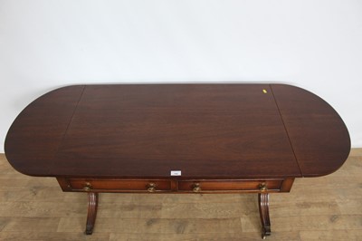 Lot 156 - Regency-style low sofa table with twin flaps and two drawers, on splayed legs, 102cm wide x 62cm deep x 56cm high