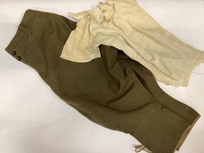 Lot 740 - Pair of Second World War Womens Land Army (W.L.A.) Khaki breeches with label to interior dated November 1942, together with a military issue polo shirt dated 1942 and an old Gurkha Kukri (3)