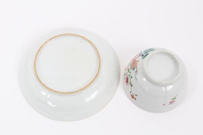 Lot 41 - Chinese famille rose export porcelain tea bowl and saucer, painted with an exotic bird in a fenced garden