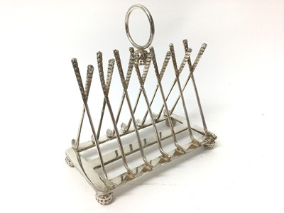 Lot 200 - 1930s American novelty silver plated golfing toast rack with golf club divisions and golf ball feet 15.5 cm long