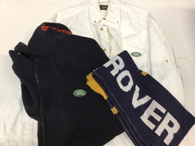 Lot 1990 - Two boxes of official Land Rover branded clothing to include shirt, caps, scarf and other items.