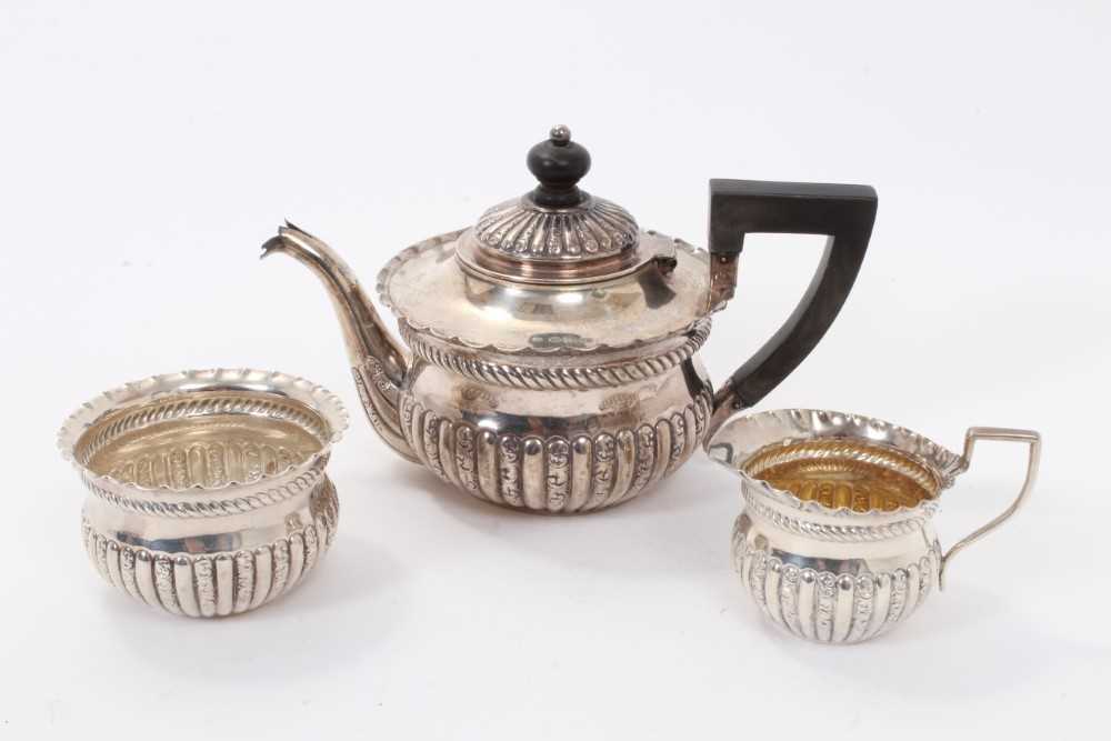 Lot 202 - Three piece silver batchelors teaset, squat form with half fluted body.