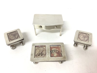 Lot 227 - Edwardian silver trough-shaped double stamp holder (Birmingham 1906), two white metal stamp holders and novelty table stamp box (Birmingham 1909)