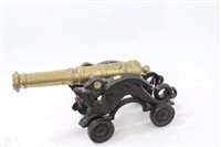 Lot 932 - Decorative 19th century brass model cannon on...