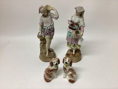 Lot 1328 - Pair of continental porcelain figures, underglaze blue marks, together with a pair of Victorian Staffordshire spaniels (4)