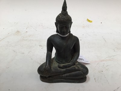 Lot 2485 - Tibetan bronze figure of Buddha, shown seated cross-legged in repose, 11cm high