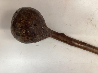 Lot 864 - Old African Knob Kerris with bulbous head on shaft with partial leather covering, 25cm in overall length.