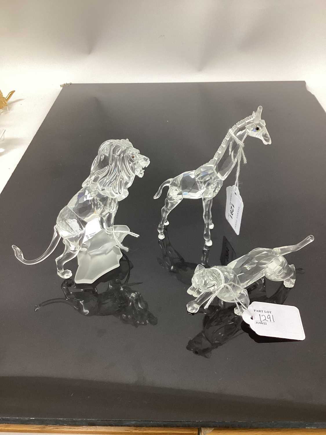 Lot 1291 - Group of seven Swarovski crystal animals including Lion, Giraffe etc