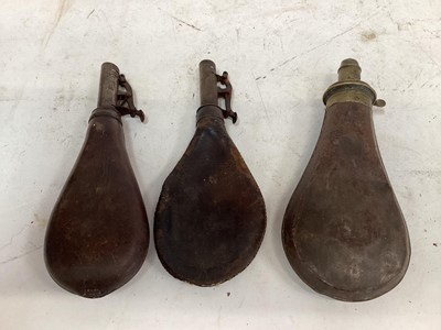 Lot 915 - 19th century Sykes powder flask, together with a Dixon & Sons leather shot flask and one other (3)