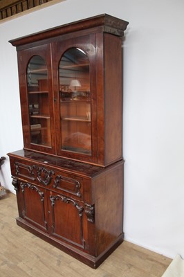 Lot 170 - Victorian mahogany two height secretaire bookcase, with fitted drawer and cupboards below, with retailers label for George Rickword of Colchester, 125cm wide x 53cm deep x 220cm high overall