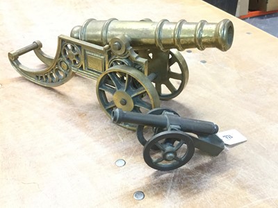 Lot 773 - Decorative brass model of a cannon, 45cm in length, together with another smaller (2)