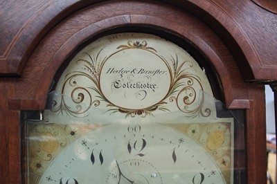 Lot 182 - Georgian 8 day long case clock by Hedge & Bannister of Colchester 
with painted dial in inlaid oak case