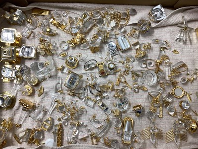 Lot 1295 - Large quantity of Swarovski crystal and gold coloured items including buildings, Viking ships, Lighthouse, pair of binoculars, Rolls Royce, train, jukebox, tennis racket, plane, World globe etc