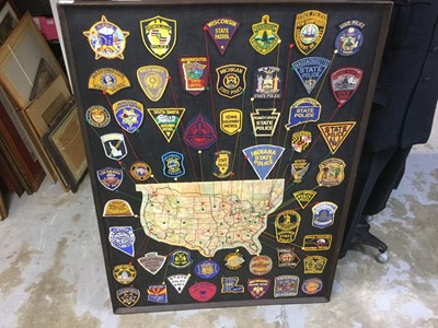 Lot 846 - Large frame displaying the Police badges of the American States, with a map, showing their locations, 125 x 93.5cm overall.