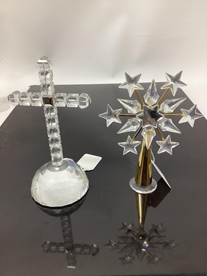 Lot 1299 - Swarovski crystal Cross of Light, 285865, together with two Swarovski tree toppers (3)