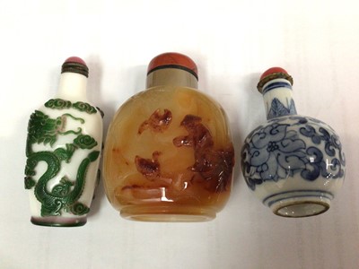 Lot 2514 - Three Chinese snuff bottles, including porcelain, glass and stone