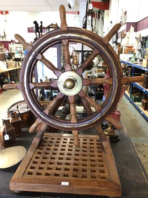 Lot 2533 - Large mahogany ships wheel on later wooden base, 95.5cm in overall height