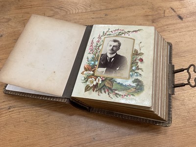 Lot 1689 - Late 19th / early 20th century embossed leather photograph album, with various photos