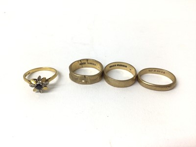 Lot 266 - 18ct gold sapphire and diamond flower head ring and three 9ct gold wedding bands (4)