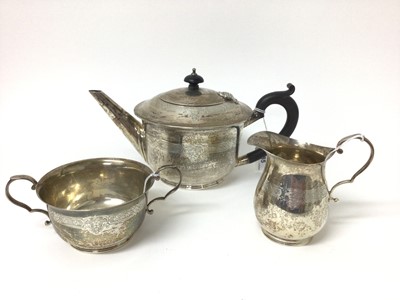 Lot 285 - George V silver teapot with band of engraved decoration, together with a matching milk jug and sugar bowl, (Birmingham 1926), maker William Hutton & Sons Ltd, teapot approximately 27cm across, all...