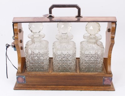 Lot 1059 - Edwardian oak tantalus with silver plated mounts and three hob-nail cut glass decanters