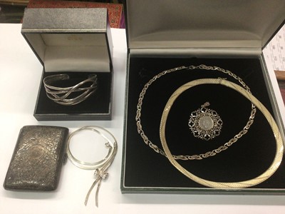 Lot 1025 - Three silver necklaces, silver bangle, silver mounted coin pendant and a silver cigarette case