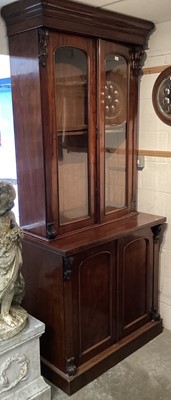 Lot 1303 - Victorian mahogany bookcase with two glazed doors enclosing 
shelves and two panelled doors below on platform base.