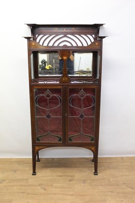 Lot 1304 - Good quality Edwardian Art Nouveau inlaid mahogany china 
display cabinet with two display tiers and two leaded and 
stained glass doors below tapered legs and block feet.