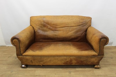 Lot 1306 - Edwardian Arts and Crafts leather covered two seater sofa 
on splayed block feet.