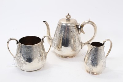 Lot 368 - Victorian silver three piece teaset comprising teapot of tapered cylindrical form with overall engraved foliate and scroll decoration and handle with ivory insulators.