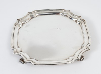 Lot 369 - George V silver card tray/salver, of square form, raised on four scroll feet, (Birmingham 1930), maker William Lister & Sons, all at 12ozs, 19cm in diameter.