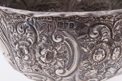 Lot 372 - Edwardian silver rose bowl of circular form with embossed floral and scroll decoration and engraved initials and inscription, (London 1904), maker Wakely & Wheeler, all at 11.5ozs, 18cm in diameter.