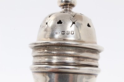 Lot 373 - George V silver sugar castor of baluster form with pieced slip in cover, raised on circular foot, (London 1916), all at 8ozs, 23cm in overall height.