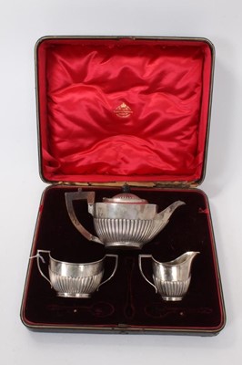 Lot 374 - Late Victorian batchelors' tea set comprising teapot of oval form with fluted decoration, together with matching milk jug and sugar bowl (London 1898), in fitted case, all at 13ozs.