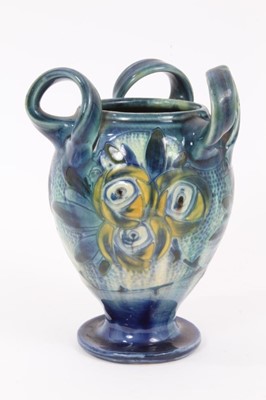 Lot 24 - Barum Barnstaple Art Nouveau three handled pottery vase with 
floral decoration.