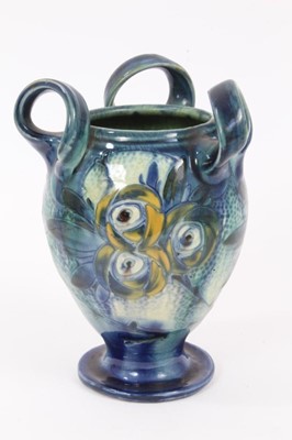 Lot 90 - Barum Barnstaple Art Nouveau three handled pottery vase with 
floral decoration.