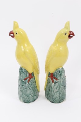 Lot 166 - Pair of Chinese porcelain yellow cockatoo perched on leafy mounted bases