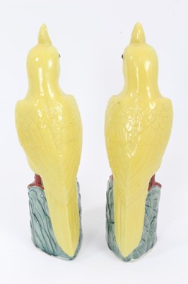 Lot 166 - Pair of Chinese porcelain yellow cockatoo perched on leafy mounted bases