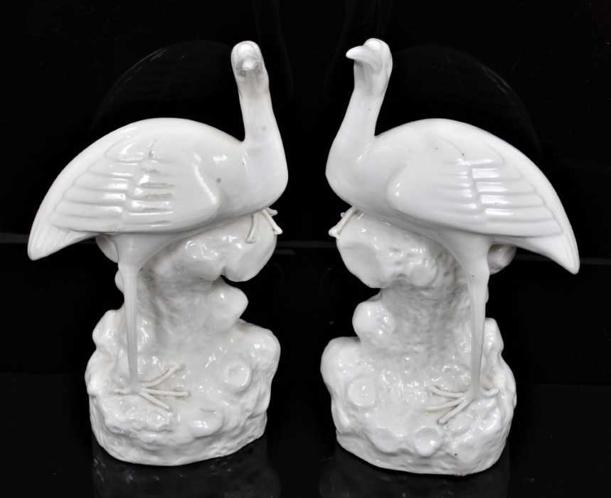 Lot 167 - A pair of oriental blanc de chine porcelain crane mantlepiece vases
