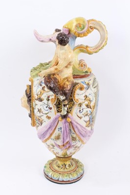 Lot 101 - 19th century Italian majolica ewer vase with fawn supports 
and mask decoration (damaged).