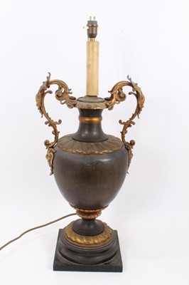 Lot 1483 - Early 20th century parcel gilt and brass two handled vase table 
lamp.